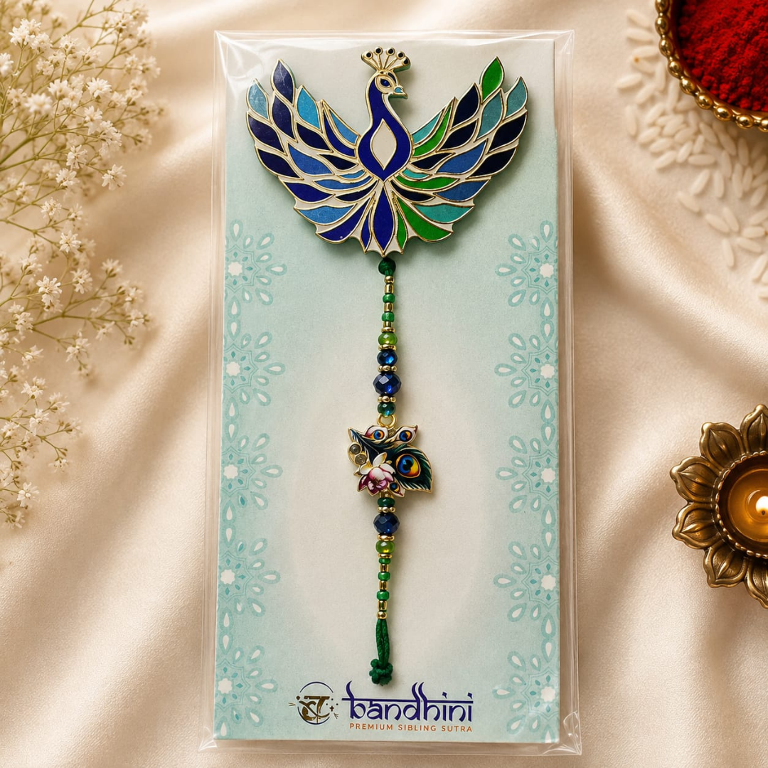 A packaged decorative hanging ornament featuring a peacock-shaped top with blue, green, and gold enamel details, a beaded string, and a small peacock charm, displayed on a light blue card with the brand name Bandhini visible at the bottom.