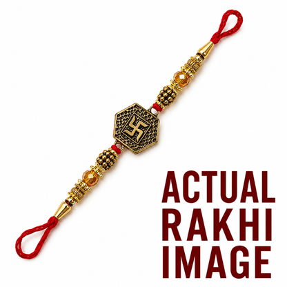 A gold and bronze beaded Rakhi with a central hexagonal charm featuring a swastika symbol, shown diagonally on a white background with red text reading 'ACTUAL RAKHI IMAGE'.